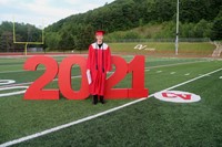 student standing next to 2021 sign