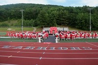 wide shot of salutatorian speaking at ceremony