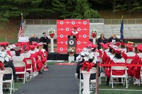 wide shot of class president speaking at ceremony