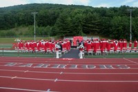 wide shot of principal speaking at ceremony