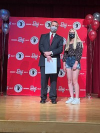 principal and student at moving up ceremony