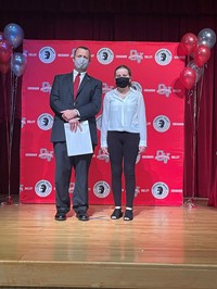 principal and student at moving up ceremony