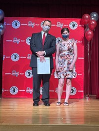 principal and student at moving up ceremony