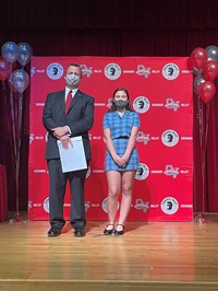 principal and student at moving up ceremony