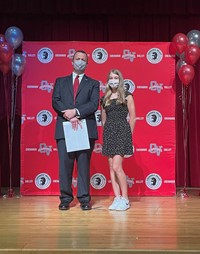 principal and student at moving up ceremony