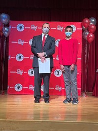 principal and student at moving up ceremony