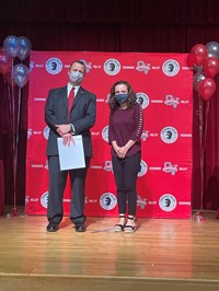 principal and student at moving up ceremony