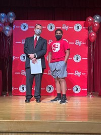 principal and student at moving up ceremony