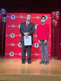 principal and student at moving up ceremony