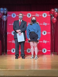 principal and student at moving up ceremony