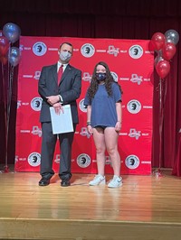 principal and student at moving up ceremony