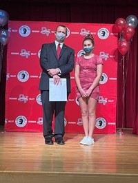 principal and student at moving up ceremony