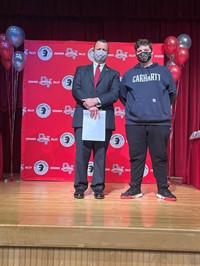 principal and student at moving up ceremony