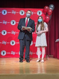 principal and student at moving up ceremony