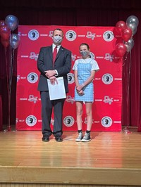 principal and student at moving up ceremony