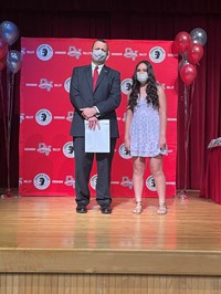 principal and student at moving up ceremony