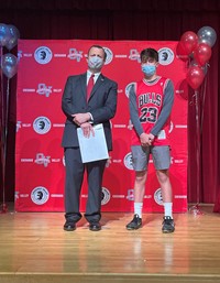 principal and student at moving up ceremony