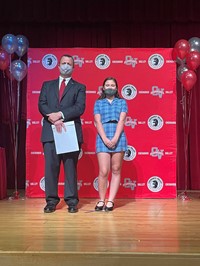 principal and student at moving up ceremony