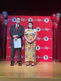 principal and student at moving up ceremony