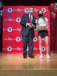 principal and student at moving up ceremony