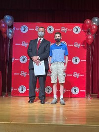 principal and student at moving up ceremony