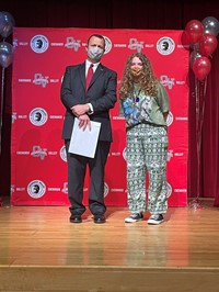 principal and student at moving up ceremony