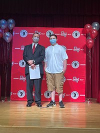 principal and student at moving up ceremony