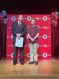 principal and student at moving up ceremony