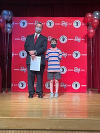 principal and student at moving up ceremony