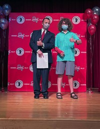 principal and student at moving up ceremony