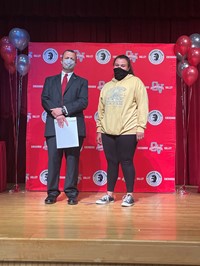 principal and student at moving up ceremony