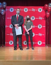 principal and student at moving up ceremony