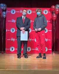 principal and student at moving up ceremony