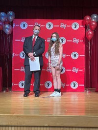 principal and student at moving up ceremony