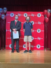 principal and student at moving up ceremony