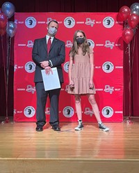 principal and student at moving up ceremony