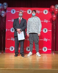 principal and student at moving up ceremony