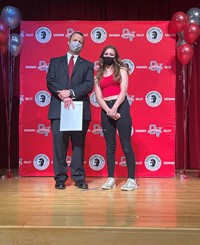 principal and student at moving up ceremony