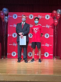 principal and student at moving up ceremony