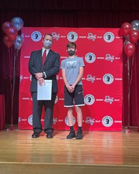 principal and student at moving up ceremony