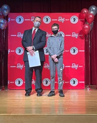 principal and student at moving up ceremony