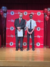 principal and student at moving up ceremony