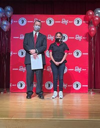 principal and student at moving up ceremony