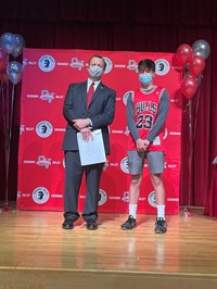 principal and student at moving up ceremony