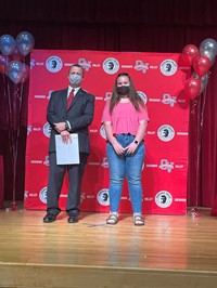 principal and student at moving up ceremony