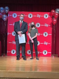 principal and student at moving up ceremony