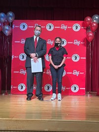 principal and student at moving up ceremony