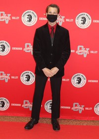 student posing on red carpet