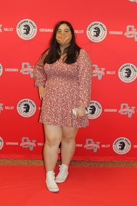 student posing on red carpet