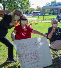 nursing home residents holding up signs